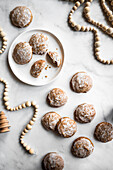 German Lebkuchen Cookies on a marble surface with holiday decorations.