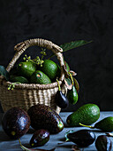 Black and green avocados in a basket