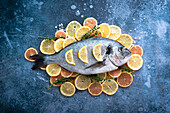 Sea bass on a bed of lemon and thyme before being cooked