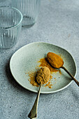 Vintage spoons with powdery spices of ginger and turmeric