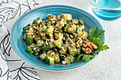 Roasted zucchini and walnut salad seasoned with parsley and dill.