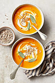 Carrot soup with ginger, sprinkled with sunflower seeds