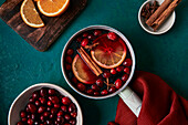 Mulled wine preparation with orange cranberries and cinnamon