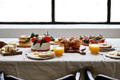 Breakfast Tablescape with Pastries, Orange Juice and Fruit