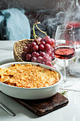 Shepherd's pie or cottage pie is a casserole with a layer of cooked meat and vegetables, topped with mashed potatoes
