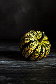 Pumpkin portrait on a dark surface and background