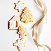 Christmas biscuits with icing on a white background with a bow