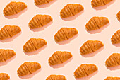 Croissant pattern over pink background