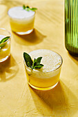 Pineapple Mint G&Ts with spout on yellow background with shadow