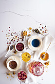 Selection of herbal teas, rose petal, calendula, lavender, and blue butterfly pea flower, known for their flavor, medicinal and nutritional properties. Negative copy space.