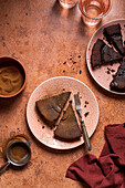 Sliced chocolate cake with cocoa powder