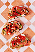 Ricotta and Parma ham toast with balsamic drizzle and cress on a tiled background