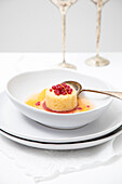 Tangerine gazpacho dessert in a white bowl