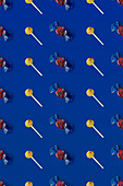 Top view of pattern of whole sweet crystal candies and lollipops arranged on blue background