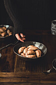 Faceless person eating healthy dumplings in bowls in rustic style for cooking lunch