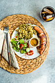 Vegetables and sausages on plate served with glass of cola drink