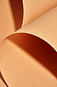 High angle of naturally rolled craft paper background with a beautiful studio light