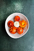 Top view of Interior decoration with bowl full of Ranunculus flower head on concrete table