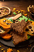 Closeup of bunch of delicious homemade biscuits placed on wooden table in Halloween style