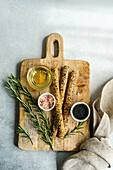 Top view of a cooking food concept with rosemary herb and salt-pepper spice