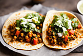 Appetizing Mexican tacos with spicy chili peppers and cilantro on plate. Generative AI