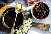 Cup of bulletproof ketogenic coffee served in ceramic mug on concrete table in the sunny morning