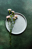 Floral table setting with fresh carnation flowers