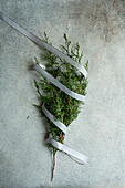 Top view of green fir twigs decorated with ribbon as symbol of Christmas celebration