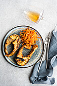 Salmon steak with spicy carrot served with a glass of dry white wine