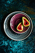 Ripe fig slices on the plates on concrete background