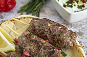 Traditionelles hausgemachtes Kafta oder Kofta Kebab aus Rind- und Lammfleisch mit Tomatensauce und Joghurt. Traditionelles arabisches und türkisches Essen. Halal-Essen