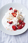 Dessert with strawberries, meringue and whipped cream viewed from above