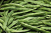 Top view full frame of heap of fresh green runner beans placed together