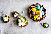 Top view easter holiday card with wreathes full of multicolor eggs on concrete background