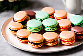 Delicious sweet assorted macaroons with colorful cream placed on white plate in cafe