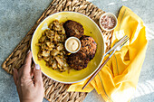 Ketogenic bowl with stewed cabbage and meat cutlets on rustic background