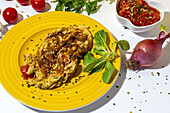 Delicious omelette with chopped parsley on plate against sun dried tomatoes and raw red onion on white background