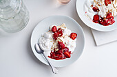 Top view image of a dessert with berries, meringue and whipped cream. Eton's mess with strawberries, sweet treat with summer mood