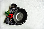 Ceramic plate ad bowl setting for Christmas dinner on concrete table on white background