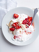 Dessert with berries, meringue and whipped cream. Closeup image of Eton's mess with strawberries, sweet treat with summer mood