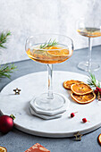 High angle of served table with orange cocktail and christmas decorations