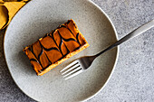 Top view of gourmet caramel cake served on ceramic plate