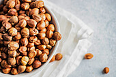 Bowl with organic hazelnuts on the napkin