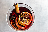 Overhead view of winter mulled wine with spices on concrete background