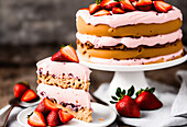 Tasty sweet creamy cake decorated with fresh strawberries on plates against blurred background
