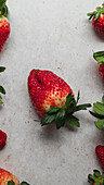 Top view of harvest of pile of fresh strawberries served on table in kitchen