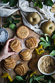 Anonymous person taking delicious apple tartlet from table in kitchen at home