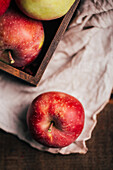 Fresh red apples in a box on table