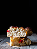 Nahaufnahme von einem Stück frischer Tomaten-Focaccia mit Rosmarin