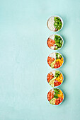 Delicious poke bowl with many ingredients seen from above